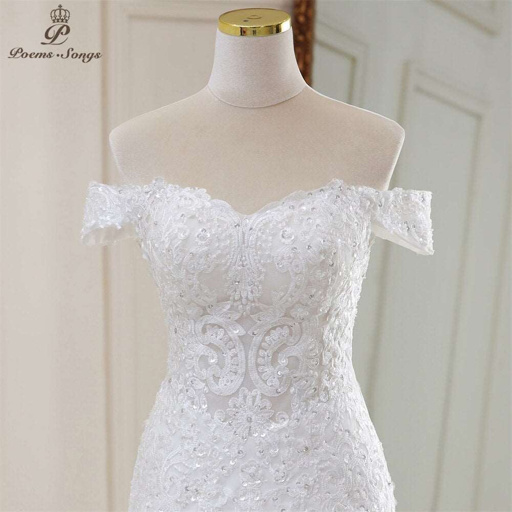 Abito da sposa a sirena con applicazioni, perline e fiori dallo scollo elegante a barchetta - Bridetobe.it